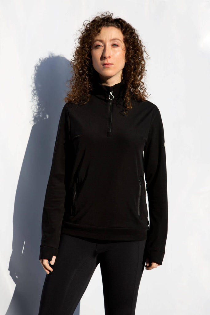 imahe of female model in all black outfit modelling the Belu Life 1/2 Zip fleece in black with zip pockets