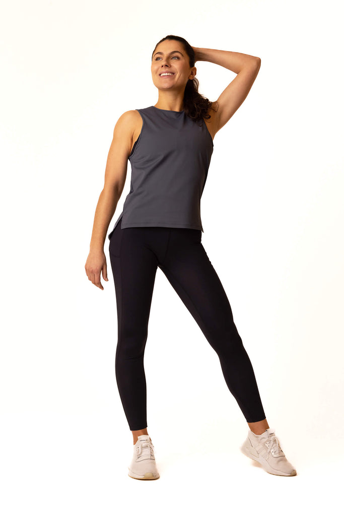 photo of female model wearing the spectrum grey women's workout vest for belu life with black Belu Life leggings